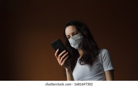 Girl Call A Doctor. Coronavirus (covid 19) Hotline. European Girl Looking At Cell Phone Display.