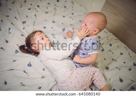 Similar – Little girl holding cookie sitting over the bed