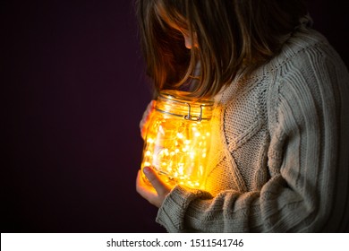 Girl And A Can With Garland, Fabulous Mood, Dark Concept, Cozy Winter Still Life, Light A Candle In Celebration For Christmas. New Year. Toning