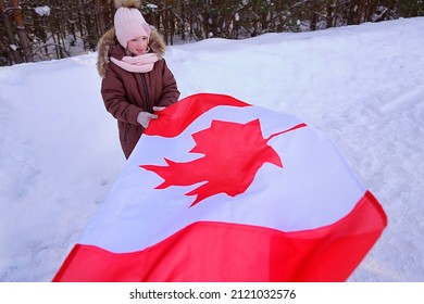 A Girl With A Canadian Flag On A Background Of Snow