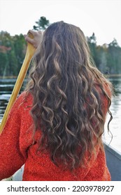 Girl In A Canoe In Quebec, Canada. Orange Shirt On A Blue Lake In Fall. 