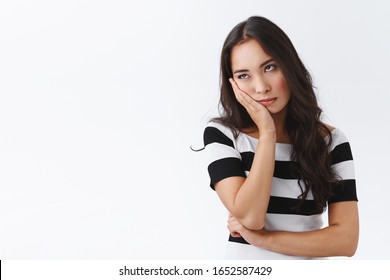 Girl cant stand long talks, wanna escape from boring meeting. Annoyed and bored fed up asian female, facepalm and roll eyes bothered, standing uninterested and dissatisfied over white background - Shutterstock ID 1652587429