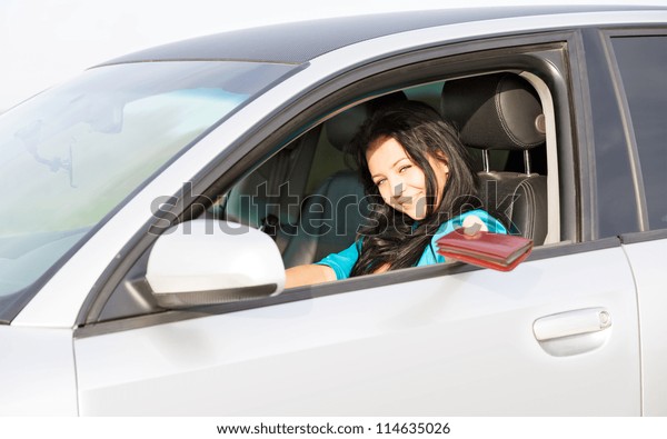 girl in the car gives\
a driver\'s license