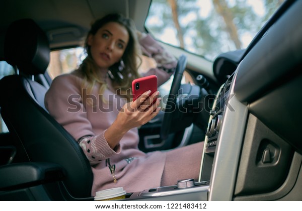 The girl in the car with\
the phone