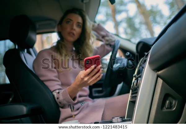 The girl in the car with\
the phone