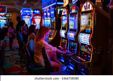 girl in a casino in Las Vegas, 
the woman plays for the slot machine, July2019