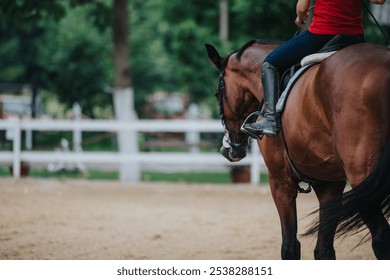 A girl in casual wear horseback riding at a ranch on a sunny day, showcasing outdoor leisure and equestrian activities. - Powered by Shutterstock