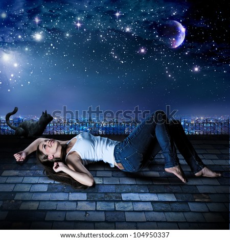 a girl and a cat are lying on a rooftop under the starry sky