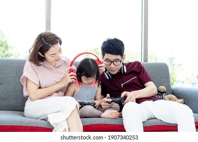 Girl with cerebral palsy syndrome learning, laughing, playing parents in white bedroom teaching children to watch, play games, learning materials TV game consoles Happy education concept