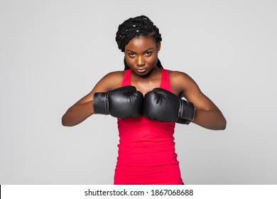 Girl champion. Portrait of beautiful black woman boxer in fighting gloves on gray background. - Powered by Shutterstock