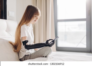 Girl Chatting Online With A Robotic Hand. Close Up Photo. Copy Space.modern New Cyber Arm For Disabled People