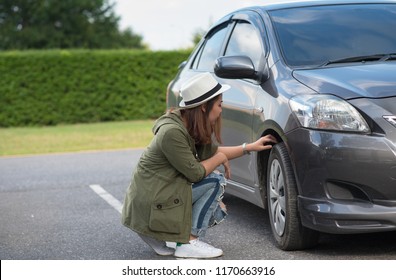 Girl Check Tires Before Leaving.Girl Checking Car Condition