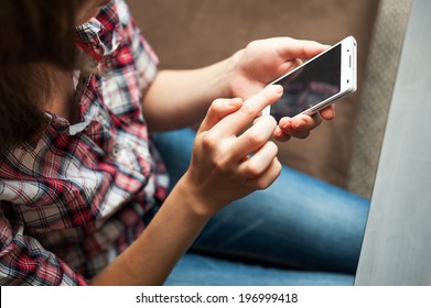 Girl in checkered shirt taping in cell phone