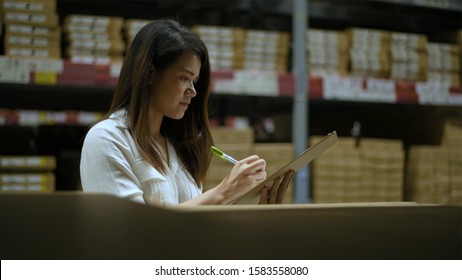 The Girl Is Checking The Balance Of Goods In The Stock Room.