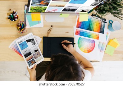 girl checking portfolio at design studio - Powered by Shutterstock