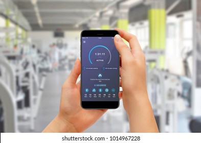 Girl Checking Progress With Fitness App While Training In Gym. Fitness Gadget