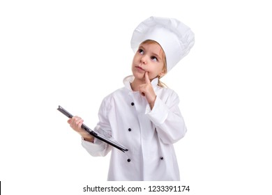 Girl Chef White Uniform Isolated On White Background. Holding The Black Ipad Screen With One Hand, And Pointing Finger On The Cheek, Thinking And Looking Up. Landscape Image