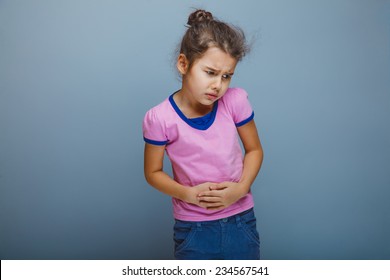 Girl Child Abdominal Pain On A Gray Background