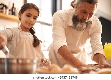 Girl, child and grandfather with baking in kitchen for cooking, cookies and teaching with support or helping. Family, senior man and grandchild with dough preparation in home for bonding and learning - Powered by Shutterstock