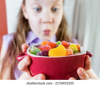 Girl Child Holding A Plate With Colorful Marmalade Selective Focus