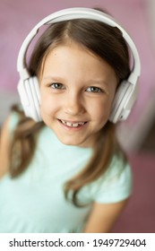 Girl Child Listening To Music With Headphones, Six Years Old 