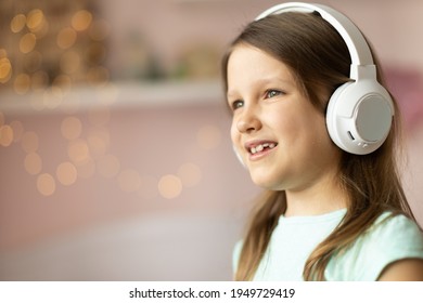 Girl Child Listening To Music With Headphones, Six Years Old 