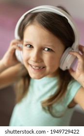 Girl Child Listening To Music With Headphones, Six Years Old 