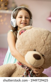 Girl Child Listening To Music With Headphones, Six Years Old 