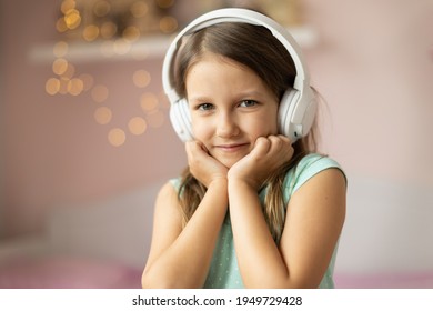 Girl Child Listening To Music With Headphones, Six Years Old 