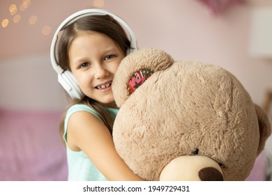 Girl Child Listening To Music With Headphones, Six Years Old 