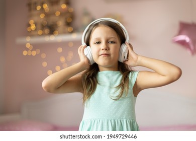 Girl Child Listening To Music With Headphones, Six Years Old 