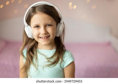 Girl Child Listening To Music With Headphones, Six Years Old 