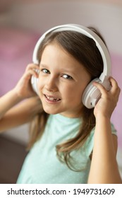 Girl Child Listening To Music With Headphones, Six Years Old 