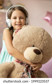 Girl Child Listening To Music With Headphones, Six Years Old 