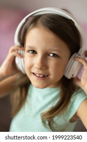 Girl Child Listening To Music With Headphones, Six Years Old 