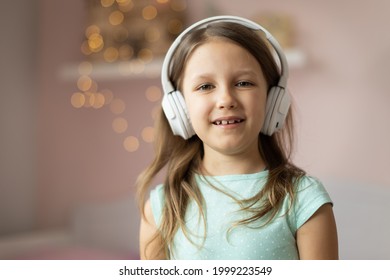 Girl Child Listening To Music With Headphones, Six Years Old 