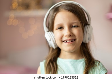 Girl Child Listening To Music With Headphones, Six Years Old 