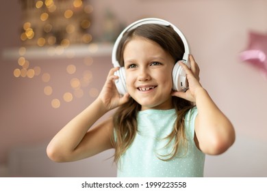 Girl Child Listening To Music With Headphones, Six Years Old 