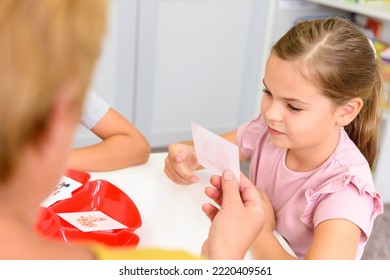 Girl In Child Occupational Therapy Session Doing Sensory Playful Exercises With Her Therapist. Child Therapy Background.