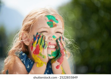 Girl, child and paint on face outdoor at school for creative learning, art assignment and education fun in nature. Student, kid and happy with colorful mess for craft, artwork and playing at academy - Powered by Shutterstock