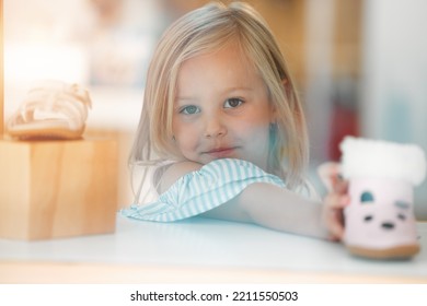 Girl Child, Retail Shopping For Shoes And Choosing Pink Kids Winter Boots On Shelf Of Childrens Fashion Shop. Portrait Of Young Customer, Toddler At Clothes Boutique In A Mall And Buying Shoe On Sale