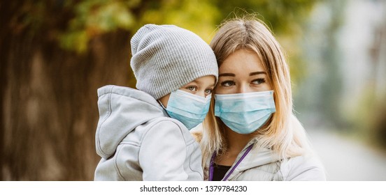 A Girl With A Child Stands On The Road In A Protective Medical Mask. Dense Smog On The Streets. Epidemic Of The Flu