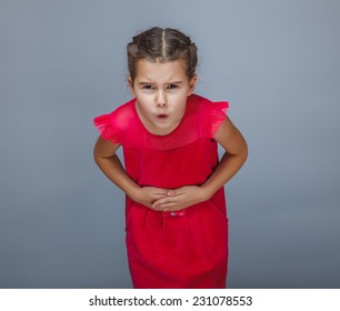 Girl Child Stomach Ache Holding Hands On Stomach On A Gray Background