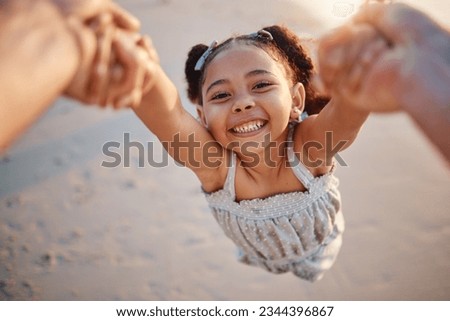 Girl child, swing and pov at beach, portrait and smile for game, holding hands or speed in summer. Young female kid, parent and spin in air, sand or happy for family bonding, love or care in sunshine