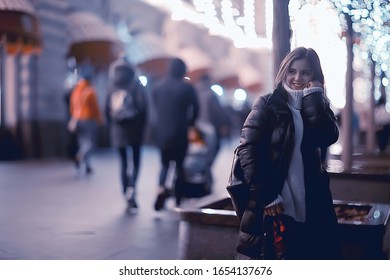 girl christmas lights evening decorated city, a young model on the background of urban decorations and garlands, night city lights - Shutterstock ID 1654137676