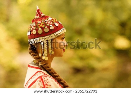 a girl in a Chuvash national costume in the autumn forest