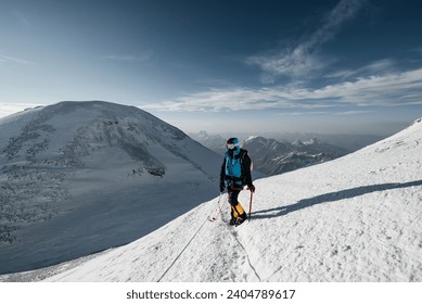 a girl climber walks along the snow-covered slope of Elbrus to the top - Powered by Shutterstock