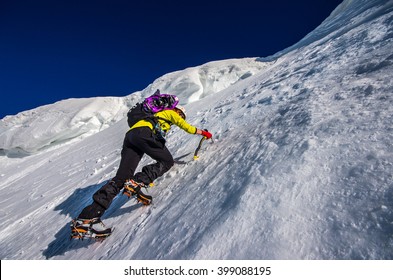 Girl Climbing The Mountain On Snow Field