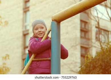 Girl Is Climbing On The Jungle Gym In The Park