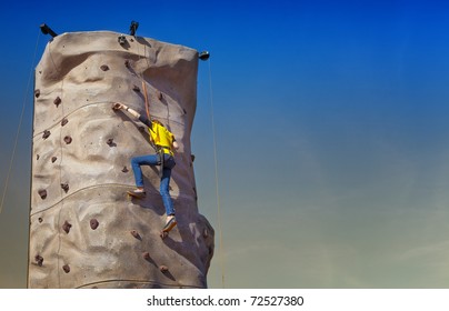 Girl Climbing Rock Wall